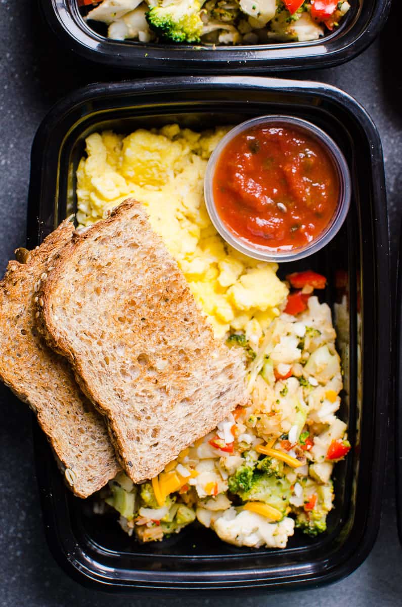 Scrambled eggs, veggies, toast and salsa in meal prep container.