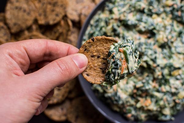 healthy spinach dip on a whole grain cracker