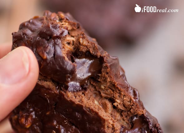 Chocolate protein cookies with a bite missing showing chocolate fudge.