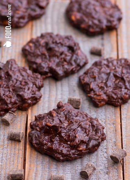 Chocolate Protein Cookies on wood board with chocolate chunks.