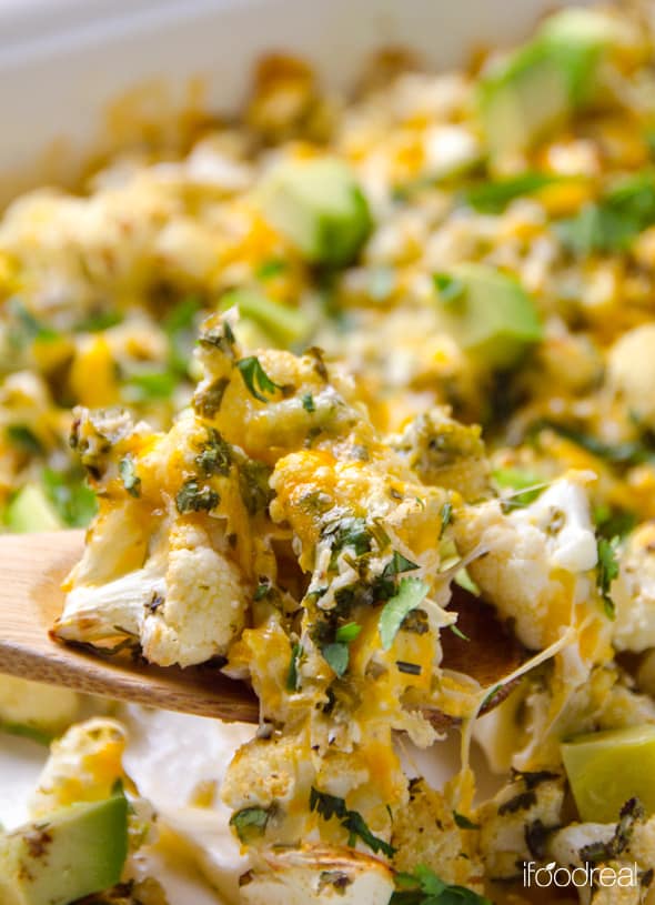 Closeup of cilantro lime cauliflower on wooden spoon. 