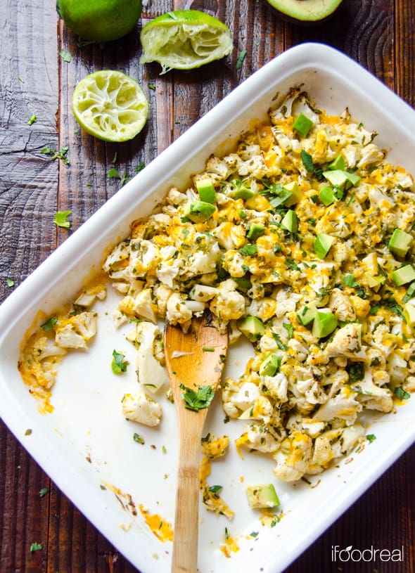 Cilantro lime cauliflower with avocado in casserole dish; half eaten with spoon.