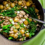 Skillet with ground turkey and potatoes with broccoli.