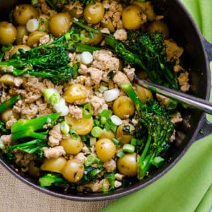 Skillet with ground turkey and potatoes with broccoli.