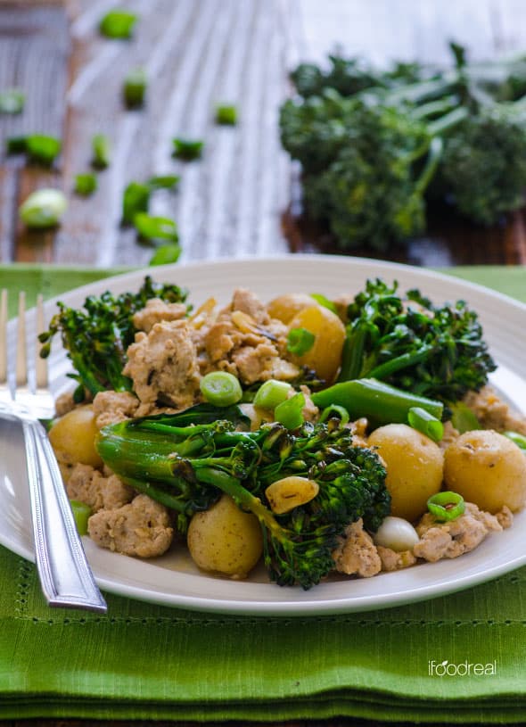 Ground turkey and potatoes with broccoli on plate.