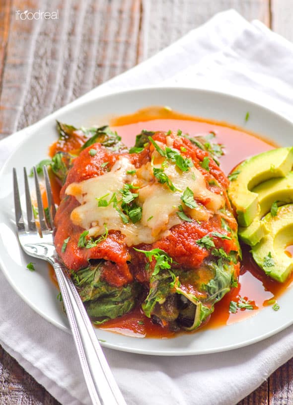 Low Carb Chicken Enchiladas on plate with side of sliced avocado