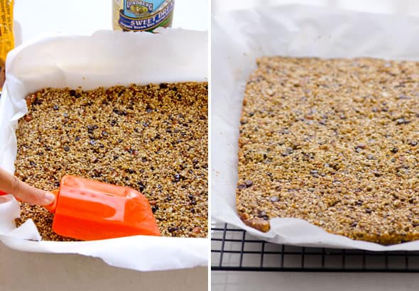 Pressing quinoa granola bars mixture into parchment paper lined baking pan.