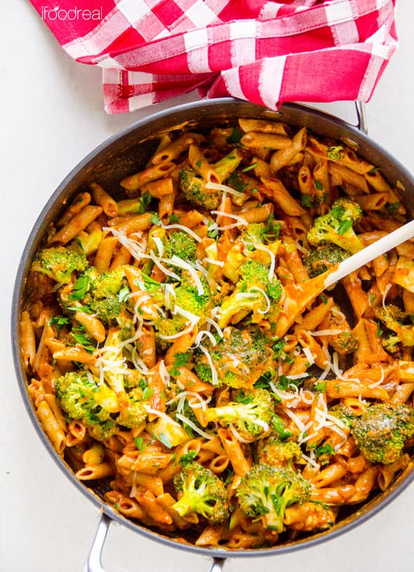 Broccoli and Penne Pasta Recipe in large skillet with checkered cloth