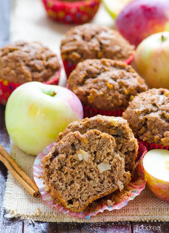 healthy apple muffin cut open with whole muffins cinnamon sticks and apples