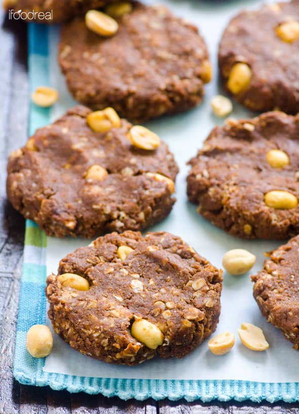 Healthy no bake protein cookies with peanuts on parchment paper on a blue towel.