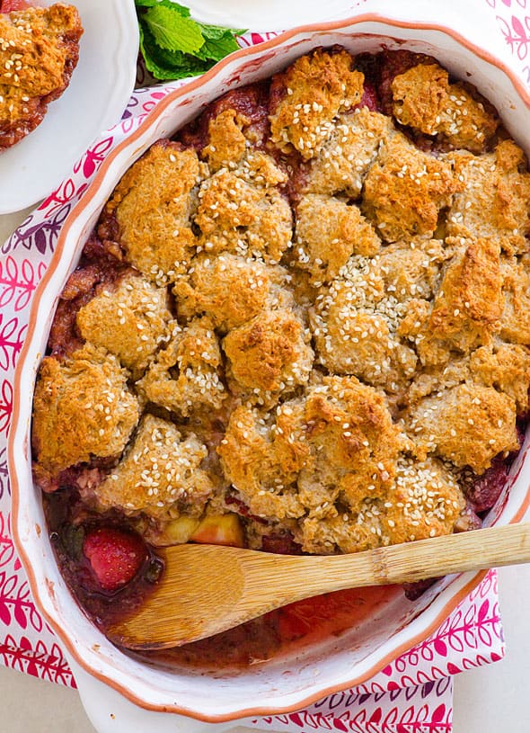Baked cobbler in dish with serving spoon