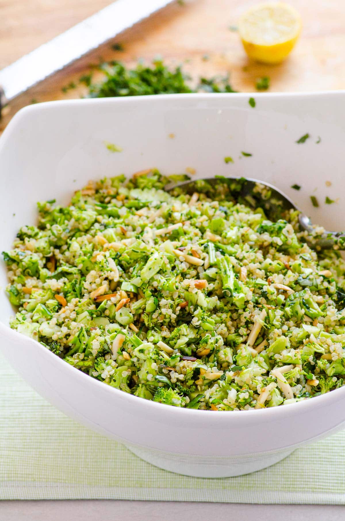 Broccoli quinoa salad in white bowl.