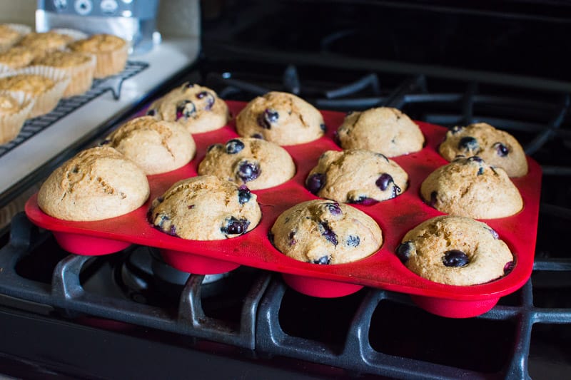 Healthy Blueberry Muffins in red silicone tin cooling on the stove