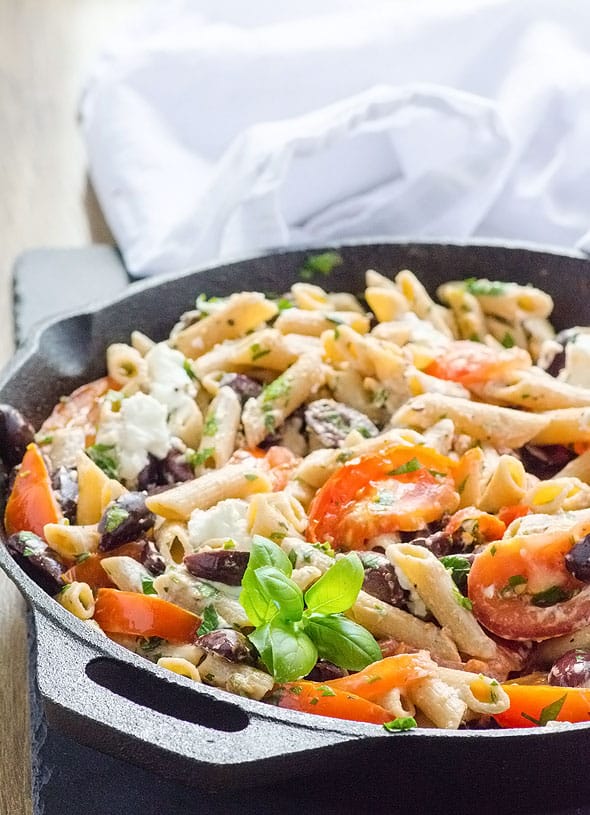 Pasta with kalamata olives, tomatoes, goat cheese and basil in cast iron skillet