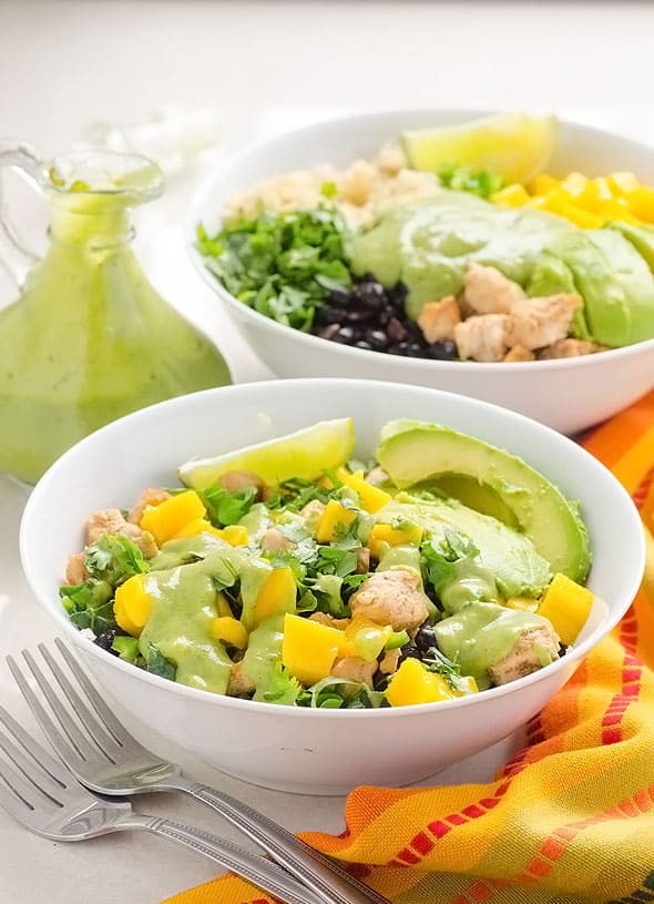 Chicken quinoa bowls with kale, mango, black beans and cilantro avocado dressing.