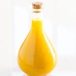 Healthy honey mustard dressing in glass jar.