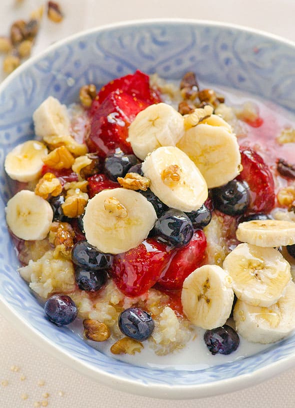 slow cooker breakfast quinoa in a bowl topped with berries and bananas