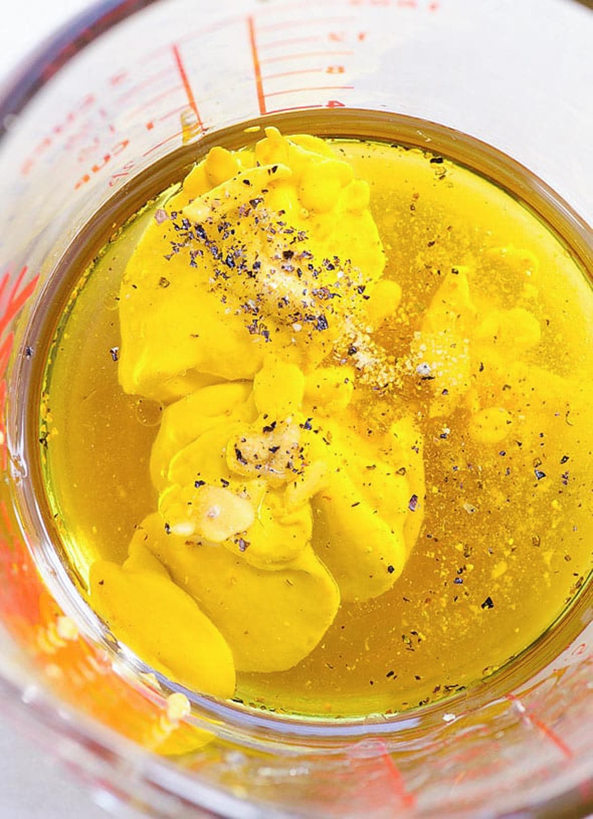 Healthy Honey Mustard Dressing ingredients in measuring cup