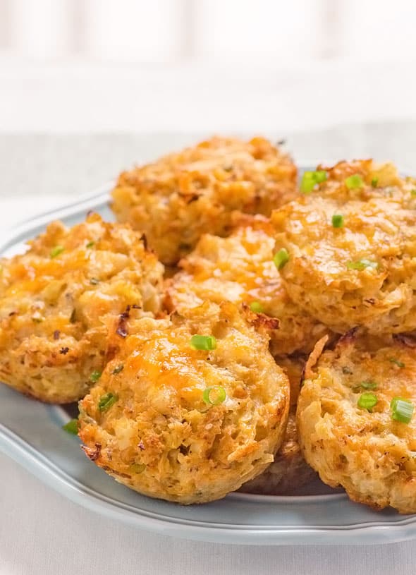 Cauliflower biscuits garnished with green onions and served on a plate.