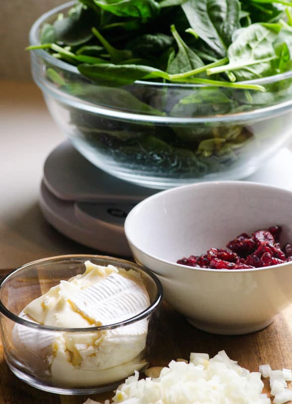 bowl of spinach, bowl of cranberries and bowl of brie