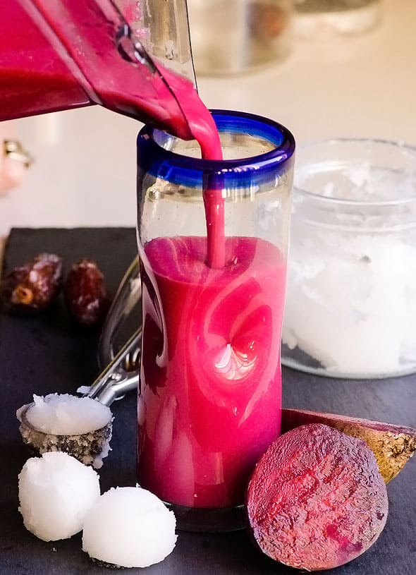 Pouring Red Smoothie into glass