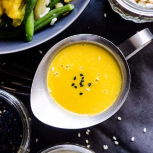 Japanese carrot ginger dressing in small silver pitcher.