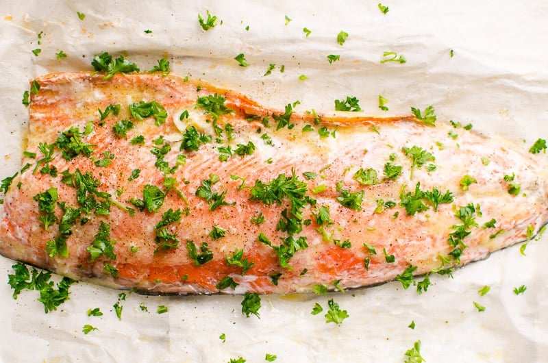 baked salmon in foil garnished with parsley