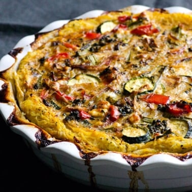 Spaghetti squash quiche with vegetables in a pie baking dish.