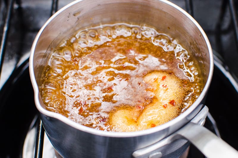 Sauce boiling in a pot on the stove. 