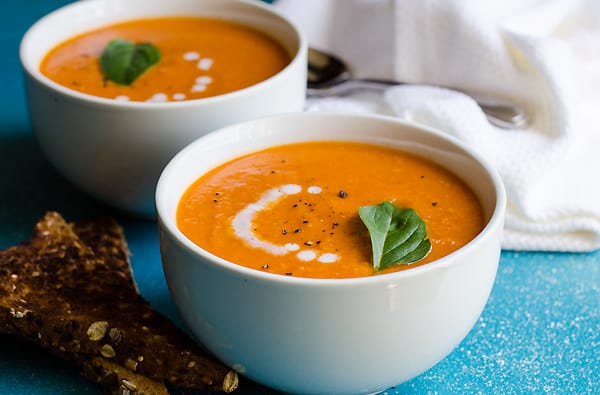 two white bowls of sundried tomato soup