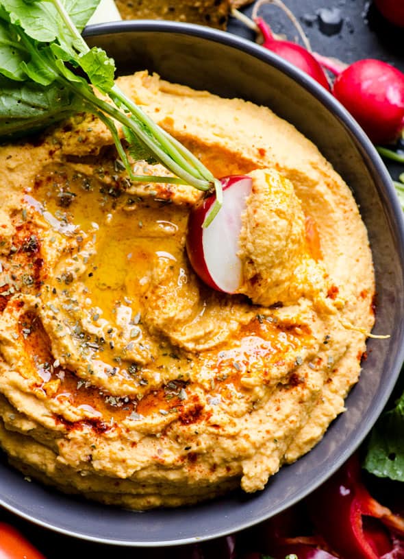 Sweet potato hummus with radish dipped in it.