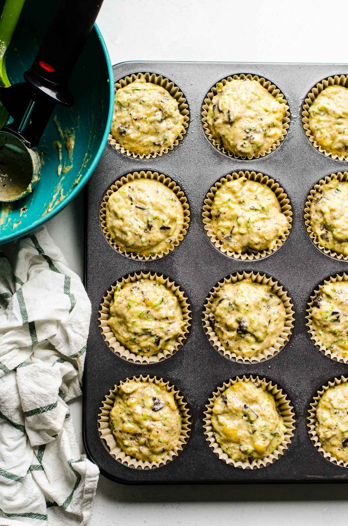 Muffin batter in muffin tin. 