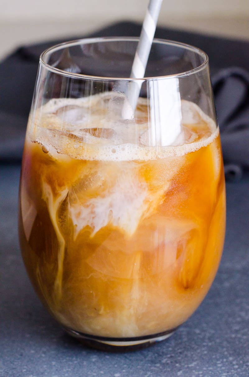 Iced coffee in a glass with a straw.