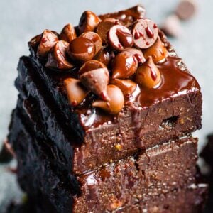 Healthy pumpkin brownies in a stack with chocolate chips on top.