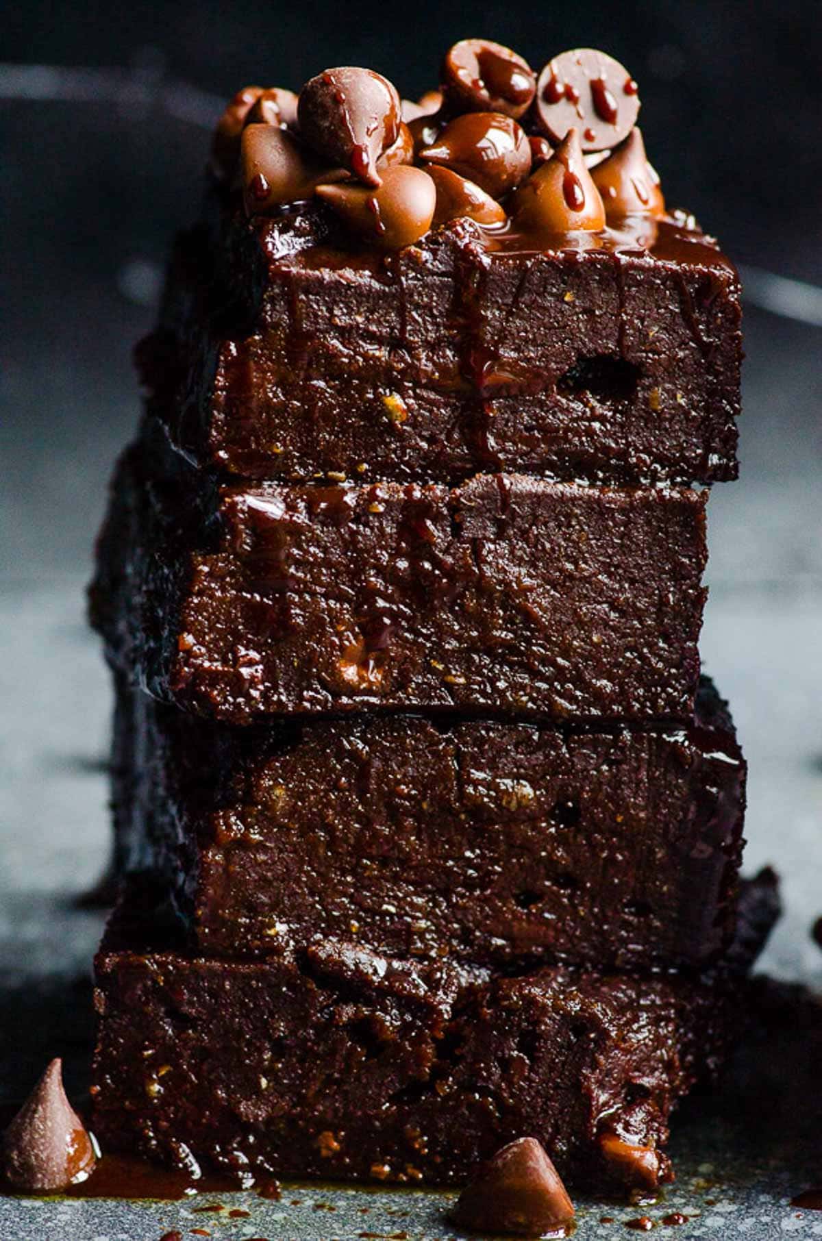 Healthy pumpkin brownies in a stack with chocolate chips on top.