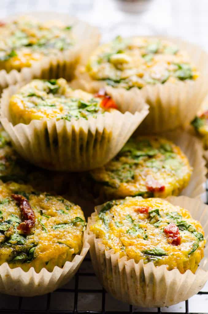 a stack of egg muffins with sun dried tomatoes and spinach