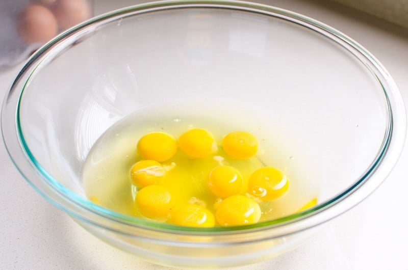 eggs cracked into glass bowl