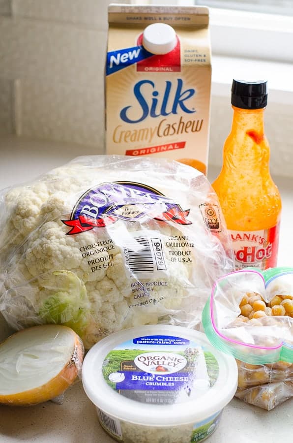 ingredients for Healthy Cauliflower Soup including onion, blue cheese, chickpeas, hot sauce, cashew milk and cauliflower