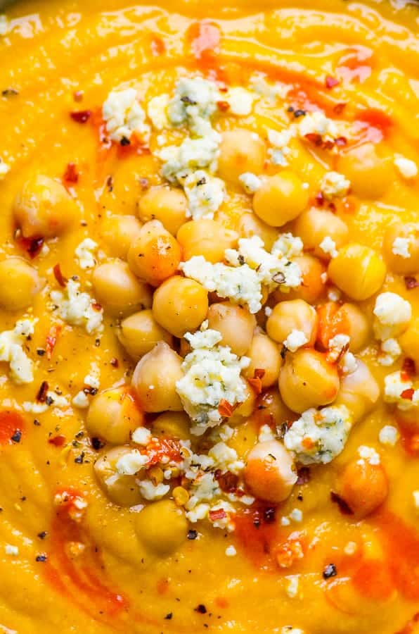close-up of Healthy Cauliflower Soup garnished with chickpeas and blue cheese