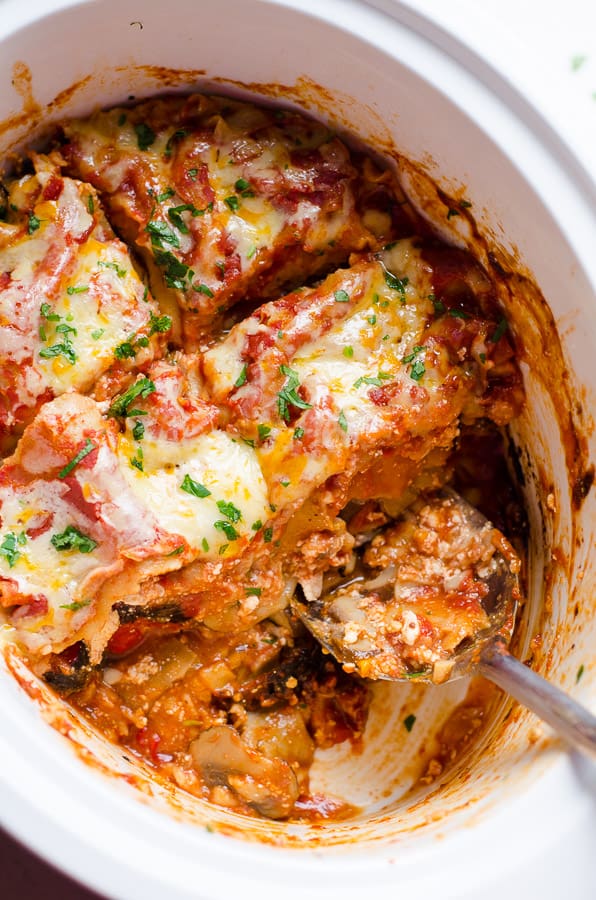 Scooping out Roasted Red Pepper Lasagna in Slow Cooker