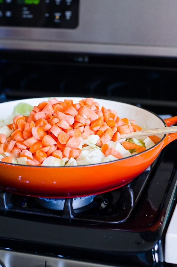 Carrots and cabbage stir fried in orange skillet