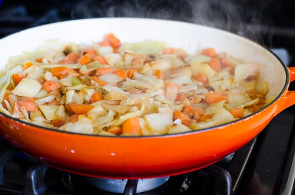 Stir fried Cabbage and Carrots in orange skillet