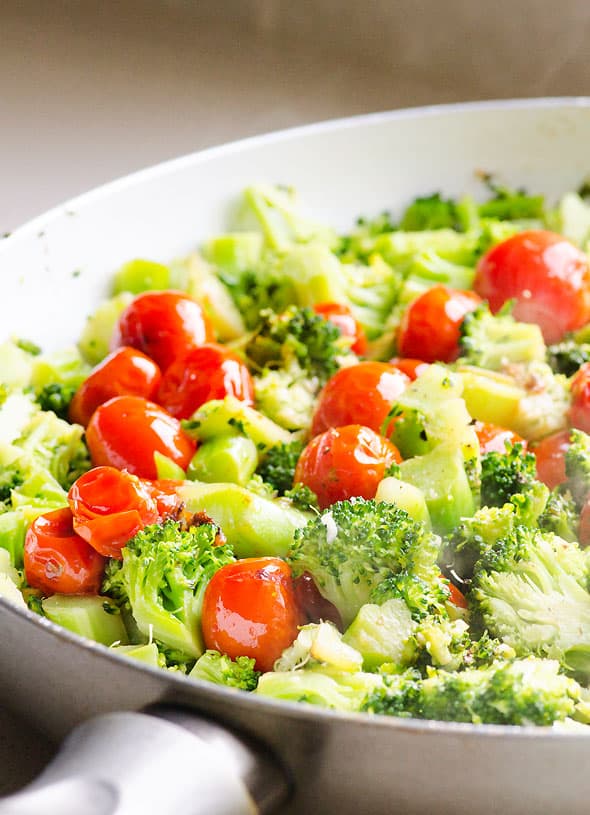 Sauteed garlic broccoli and tomatoes in the skillet.