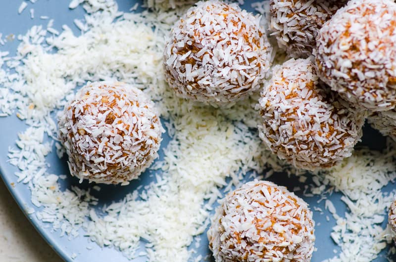 coconut protein balls on plate with coconut