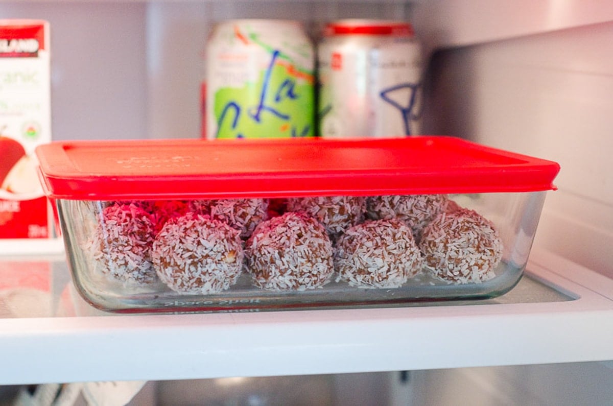 Protein balls in glass container in the fridge.