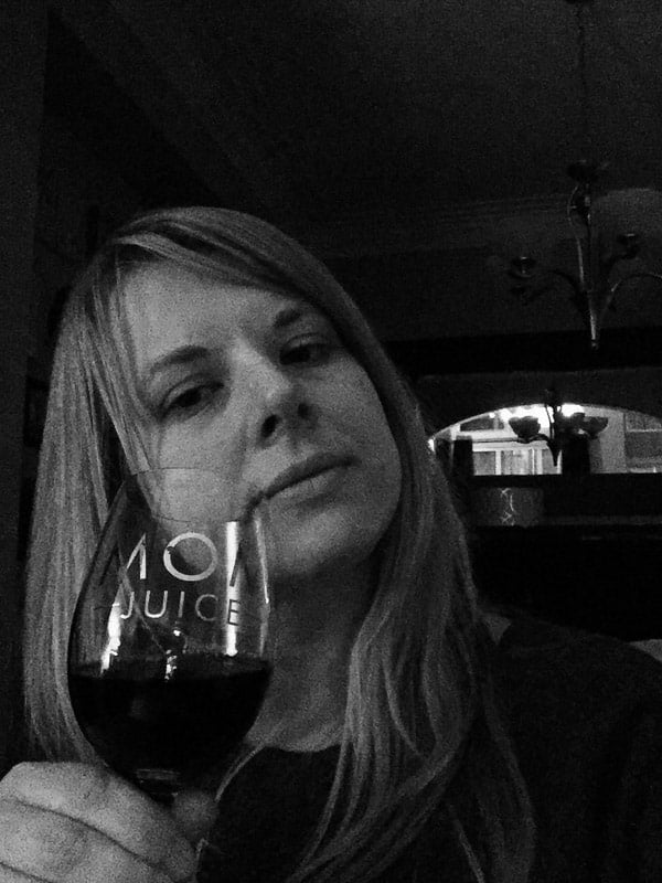 A woman holding a glass of wine. 
