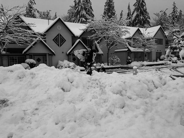 A house and street covered in snow.