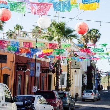 A festive street in Mexico with flags.