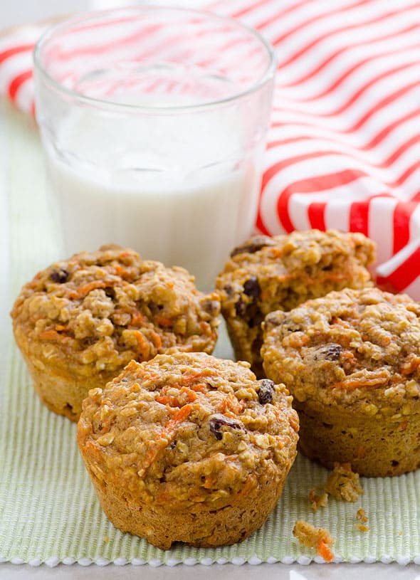 carrot oatmeal muffins with milk and striped linen towel