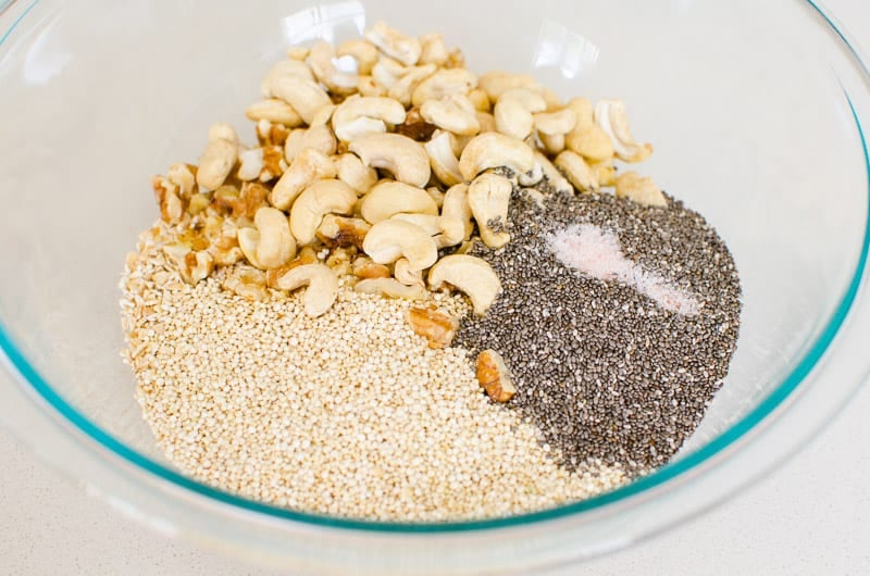 Bowl of quinoa, chia seeds, nuts, salt; unmixed